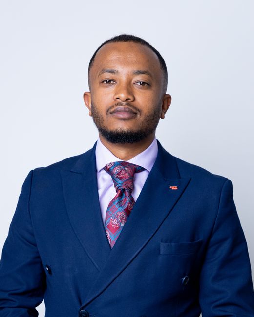 Teshome Girma — studio portrait in a navy suit